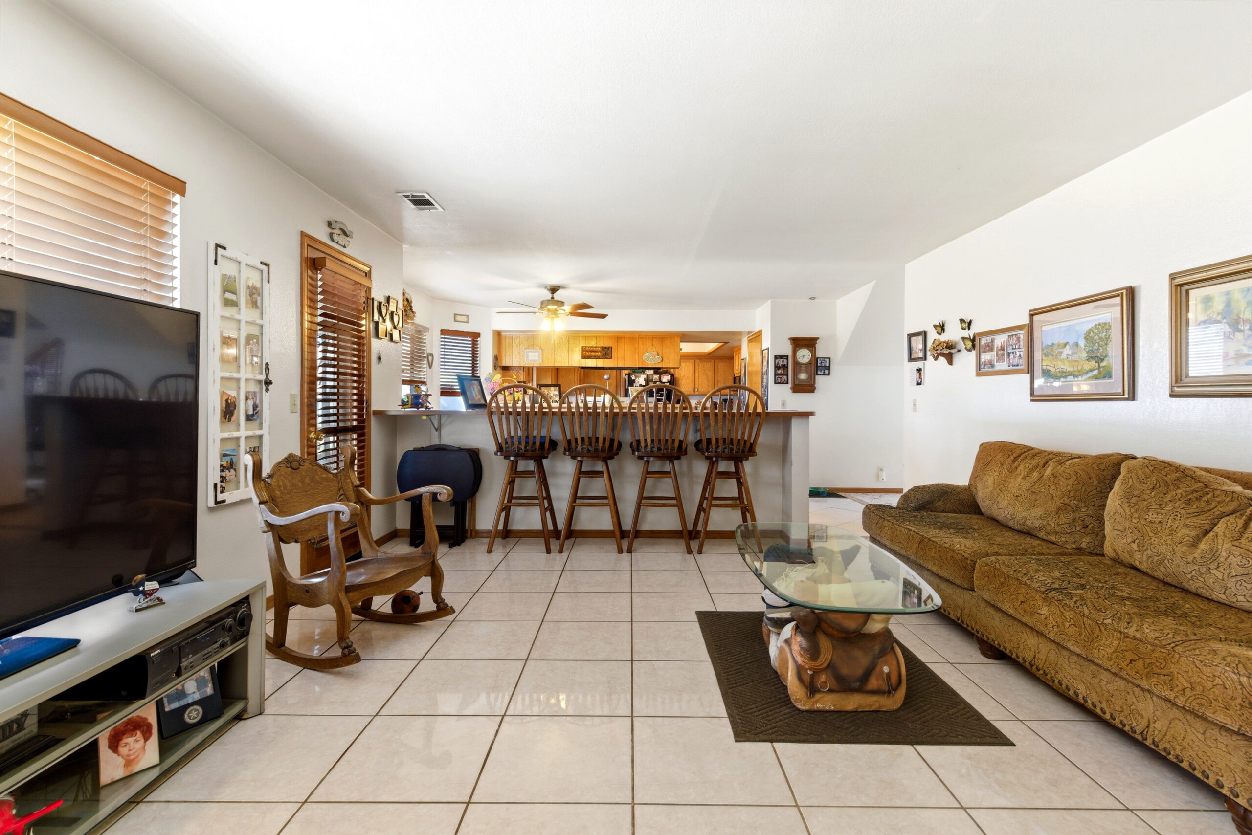 Living area with open flow toward kitchen bar seating at 11468 Kiowa Rd Apple Valley