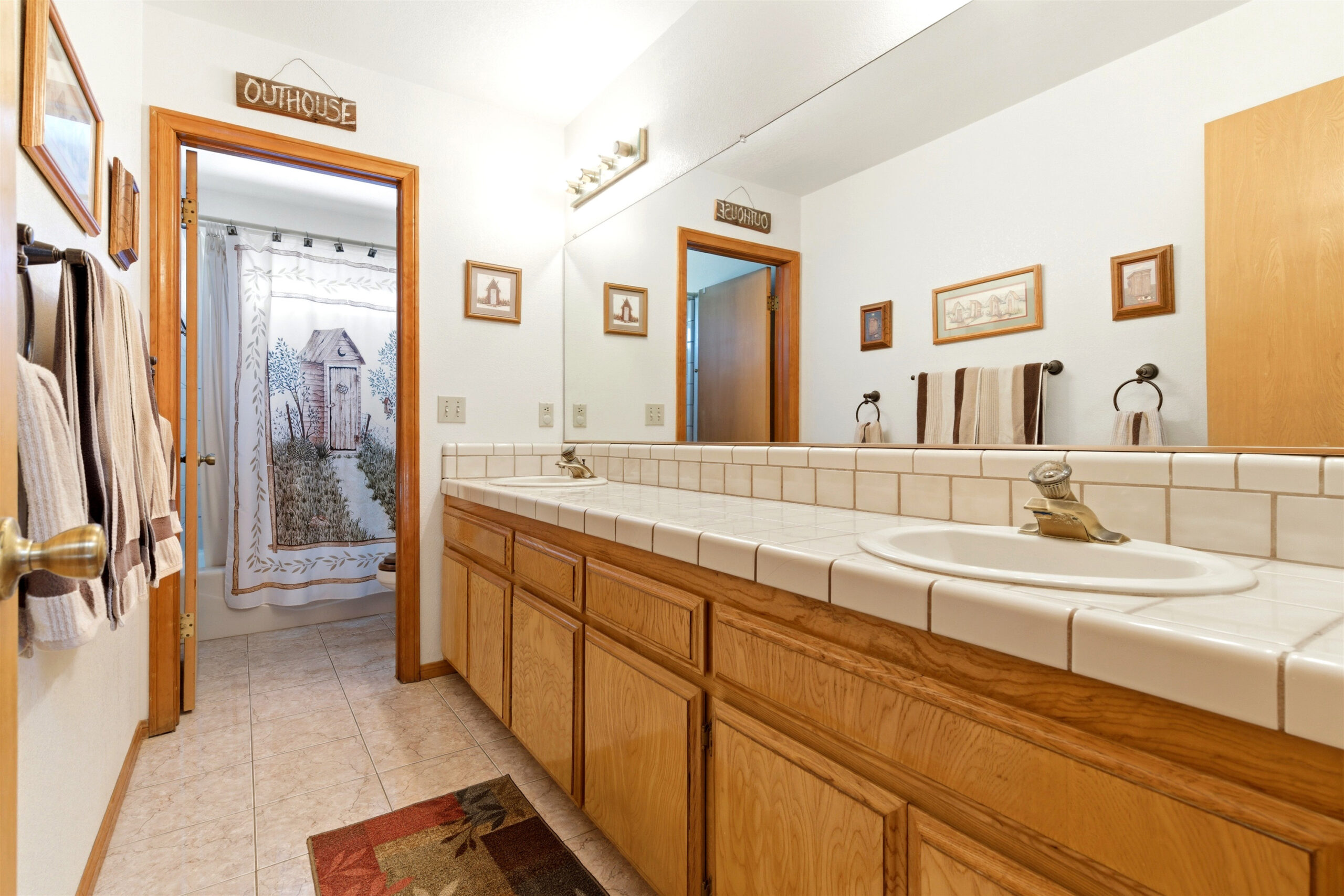 Bathroom with dual sinks and long counter at 11468 Kiowa Rd Apple Valley