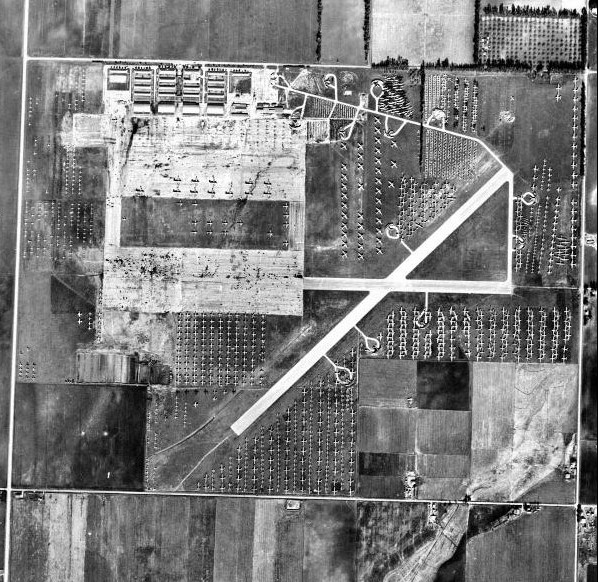 Historic aerial view of Chino Airport area with rows of military aircraft after World War II