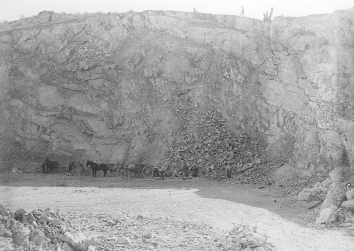 Historic limestone quarry near Oro Grande California with workers and horse-drawn wagons